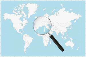 Magnifying glass showing a map of Monaco on a world map. vector