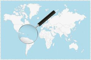 Magnifying glass showing a map of Antigua and Barbuda on a world map. vector