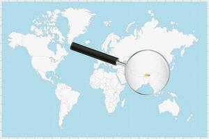 Magnifying glass showing a map of Bhutan on a world map. vector