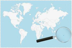 Magnifying glass showing a map of Fiji on a world map. vector