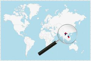 Magnifying glass showing a map of Laos on a world map. vector