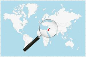 Magnifying glass showing a map of Jordan on a world map. vector
