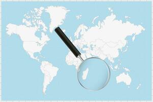 Magnifying glass showing a map of Mauritius on a world map. vector