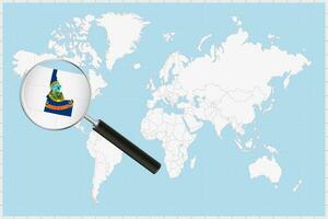 Magnifying glass showing a map of Idaho on a world map. vector