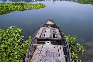 old wooden boat lake blue water Natural landscape view  in Bangladesh photo