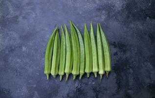 Fresh organic vegetables Lady's Finger or Okra on the Dark concrete floor photo