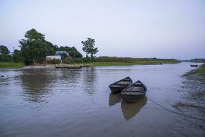 landscape view of Traditional wooden fishing boats on the shore of the Padma River in Bangladesh photo