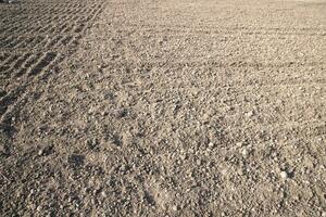 Brown crushed soil peat field abstract texture may be used as a  background wallpaper photo