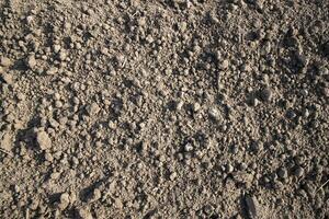 Brown crushed soil peat field abstract texture may be used as a  background wallpaper photo