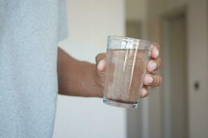 holding A dirty glass of water photo