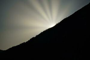 Sunrise on a mountain peak in Norway. The mountain in the shade. Landscape shot photo