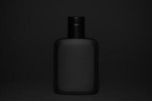 Macro photography of black perfume bottle isolated on black background photo