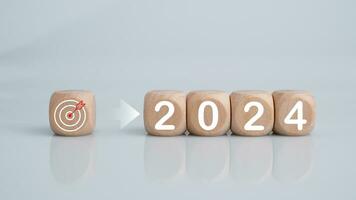 Wooden blocks lined up with the letters 2024. Represents the goal setting for 2024, the concept of a start. financial planning development strategy business goal setting photo