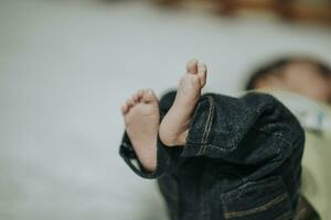 Little baby feet in mother's hands photo