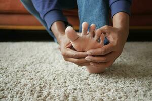 Close up on young man suffering feet pain photo