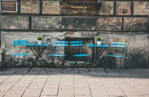 Blue chairs and tables in a street cafe photo