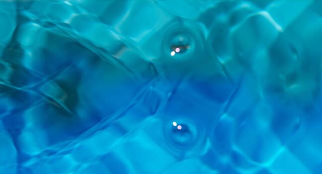 Blue water with ripples on the surface. Defocus blurred transparent white-black colored clear calm water surface texture with splash and bubbles. Water waves with shining pattern texture background. photo