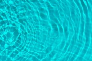 Blue water with ripples on the surface. Defocus blurred transparent white-black colored clear calm water surface texture with splash and bubbles. Water waves with shining pattern texture background. photo