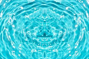 Defocus blurred transparent blue colored clear calm water surface texture with splashes reflection. Trendy abstract nature background. Water waves in sunlight with copy space. Blue watercolor shine. photo