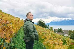 Outdoor portrait of middle age 55 - 60 year old man enjoing nice autumn day in vineyards, healthy and active lifestyle photo