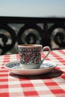 a cup of turkish coffee on table photo