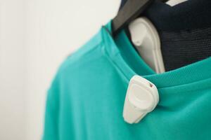 Clothing security tag on a shirt , photo