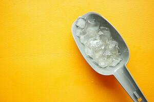 top view of many ice cubes on orange background photo