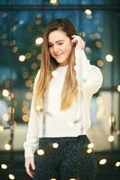 Portrait of young romantic girl posing between small lights photo