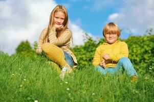 Portrait of 2 funny children playing together outside photo