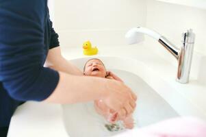 The first time bath for newborn baby in hospital photo