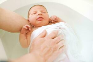 The first time bath for newborn baby in hospital photo