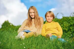 Portrait of 2 funny children playing together outside photo