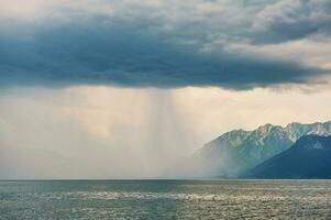 Beautiful landscape with rain over Alps and lake Geneva photo