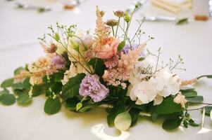 Beautiful summer table flowers bouquet arrangement for festive event photo