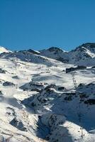 View of a snow track in Sierra Nevada Spain with chairlifts photo