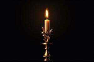 A vintage candle burning in a gold candelabra is isolated on a dark background. photo