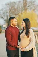 Outdoor portrait of beautiful pregnant couple, early spring image photo