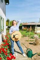 Outdoor portrait of happy young woman enjoying nice spring day in garden photo