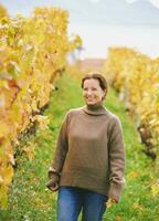 Outdoor portrait of happy laughing woman hiking in autumn vineyards, Lavaux, Switzerland photo