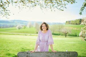 Outdoor spring portrait of happy young woman enjoying nice sunny day photo