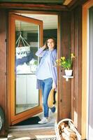 Portrait of happy young pregnant woman stanting in the doorway, springtime photo