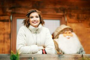 Outdoor portrait of happy young woman at Christmas market photo