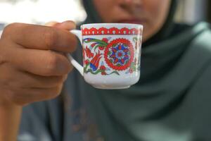 women drinking turkish coffee at cafe photo