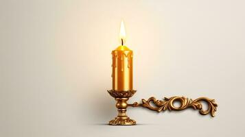 A single antique candle burns inside a shining metallic holder, isolated on a white background. photo