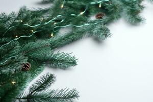 AI generated christmas tree with garland and pine cones on white background photo