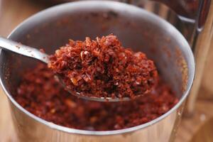 red chili pepper on silver spoon photo