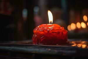 ai generado un rojo vela es iluminado en un oscuro habitación foto