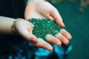 AI generated a person holding a green glitter in their hands photo