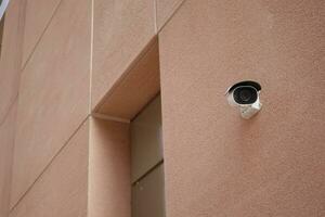 CCTV security camera operating on modern buildings outdoor photo