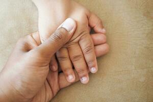 father holding hand of baby child, photo